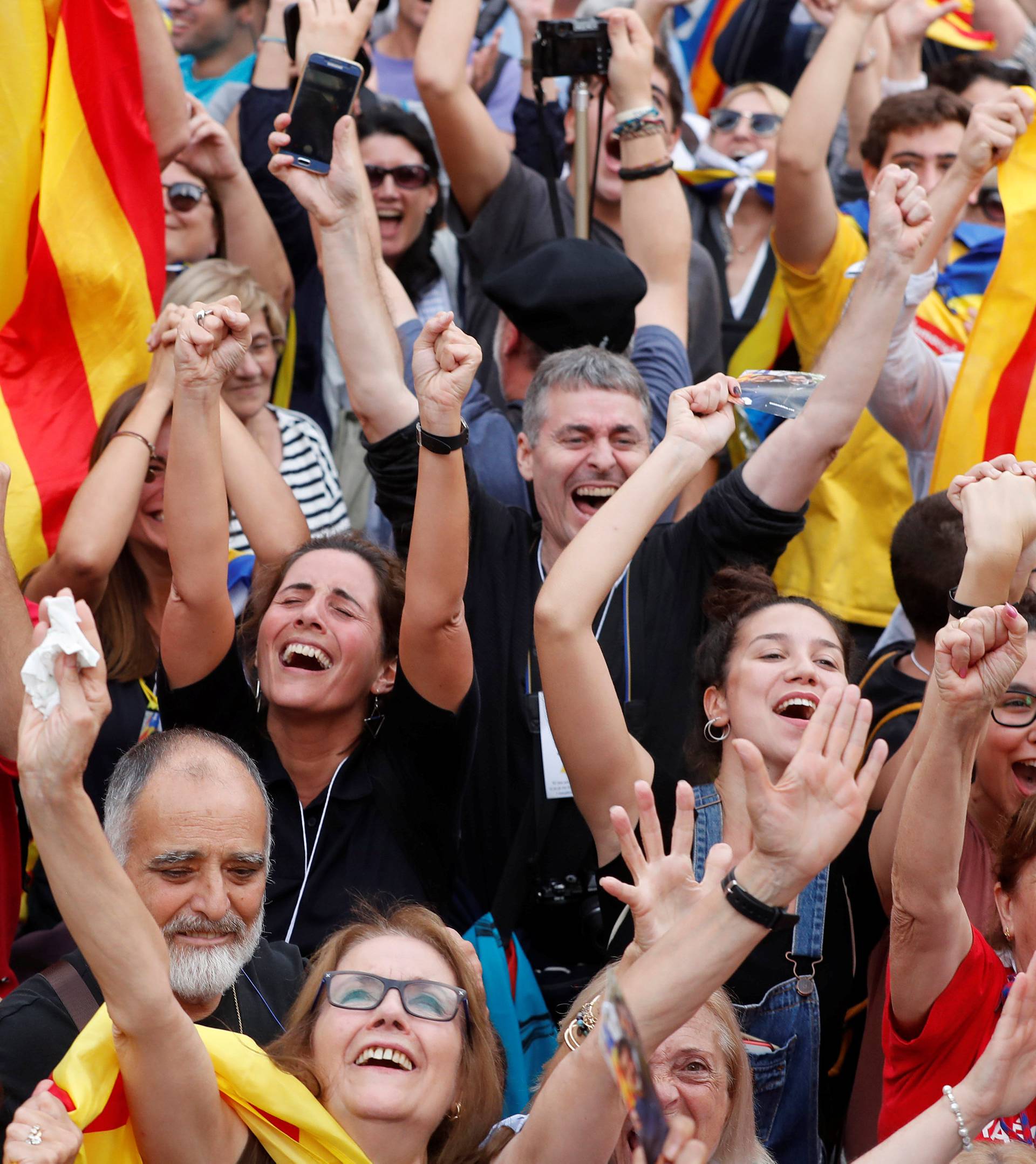 People celebrate after the Catalan regional parliament passes the vote of independence from Spain in Barcelona