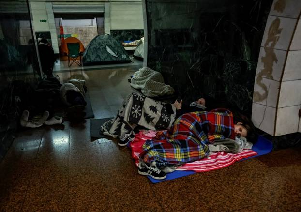 People take shelter inside a metro station during a Russian missile and drone attack in Kyiv