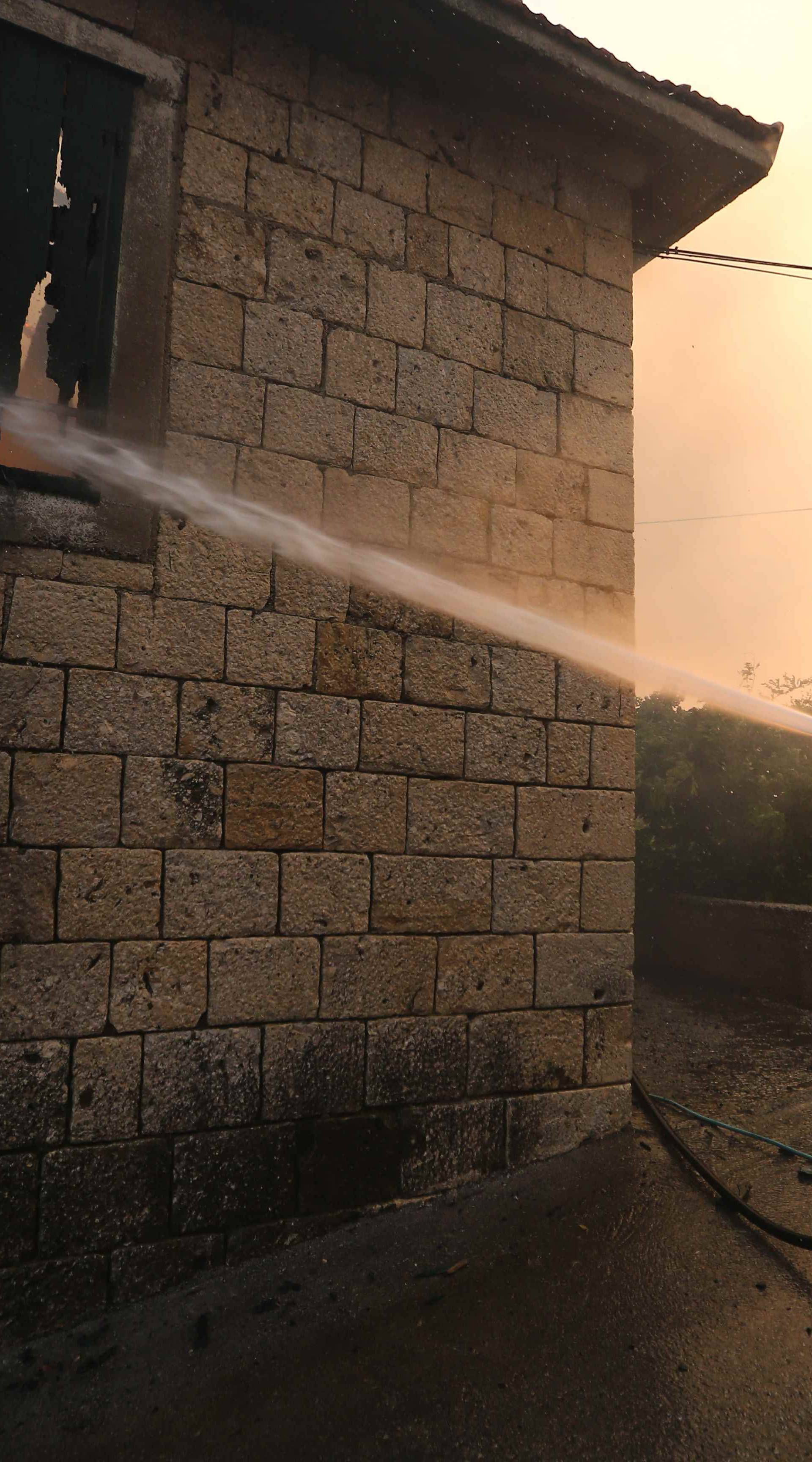 A firefighter tries to extinguish a wildfire in the village of Mravince near Split