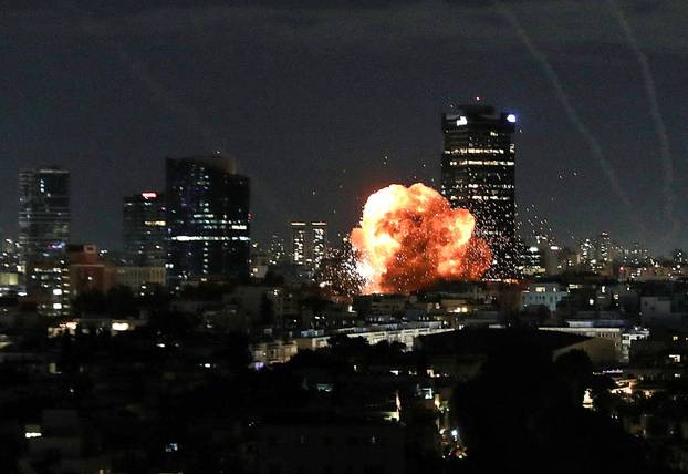 An explosion caused by a projectile impact after Iran launched missiles into Israel following Israel and the U.S. launched strikes on Iran, in Tel Aviv