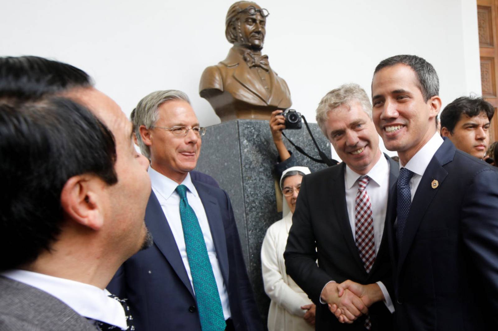 German ambassador to Venezuela Daniel Martin Kriener and Venezuelan opposition leader Juan Guaido shake hands during a news conference with accredited diplomatic representatives of the European Union in Caracas