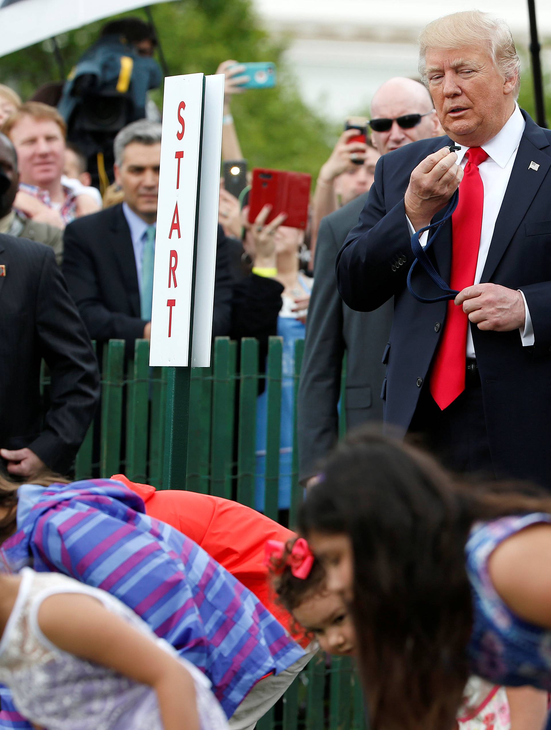 U.S. President Donald Trump watches children roll Easter Eggs at 139th annual White House Easter Egg Roll on the South Lawn of the White House in Washington