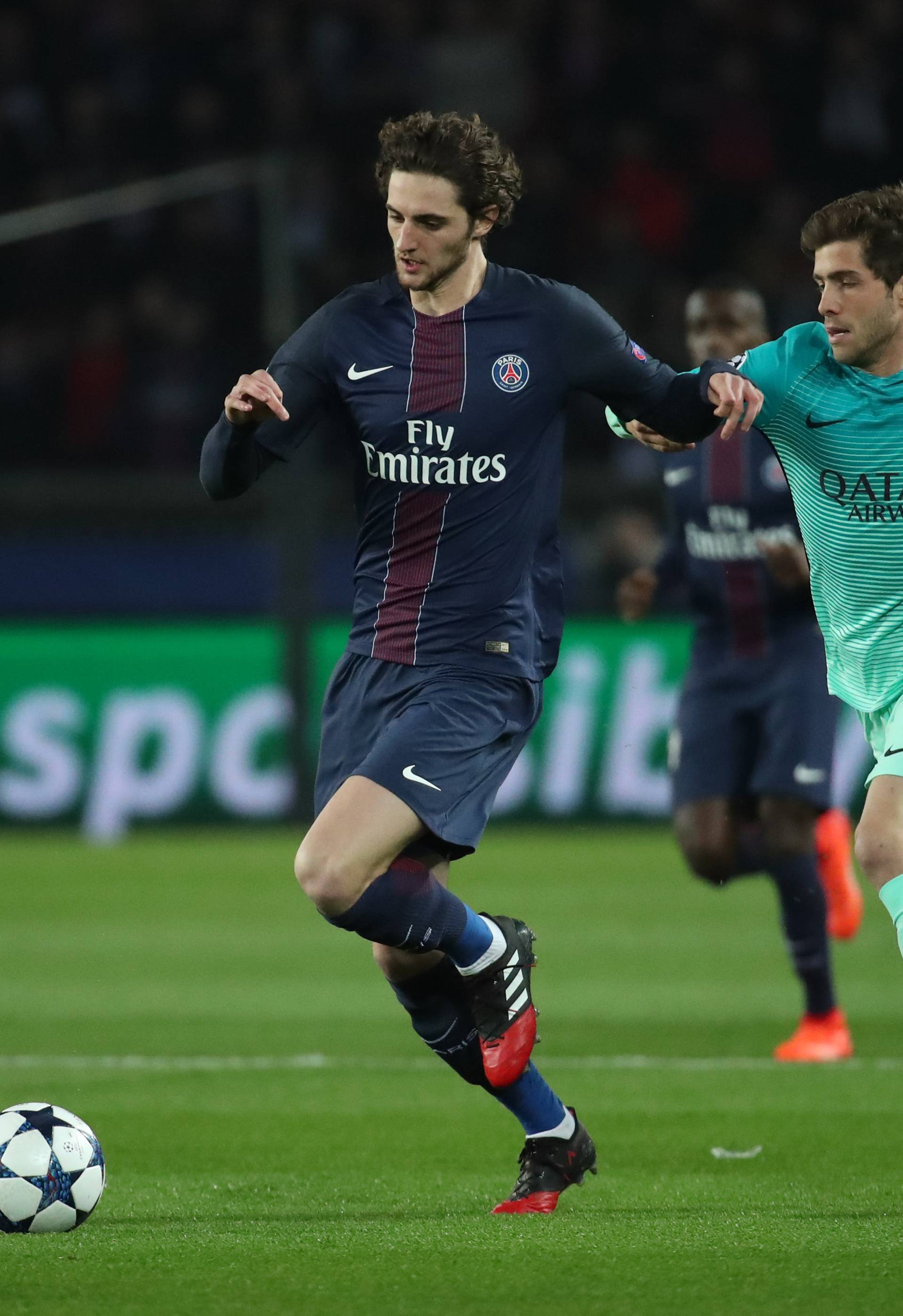 Paris Saint-Germain's Adrien Rabiot in action with Barcelona's Sergi Roberto