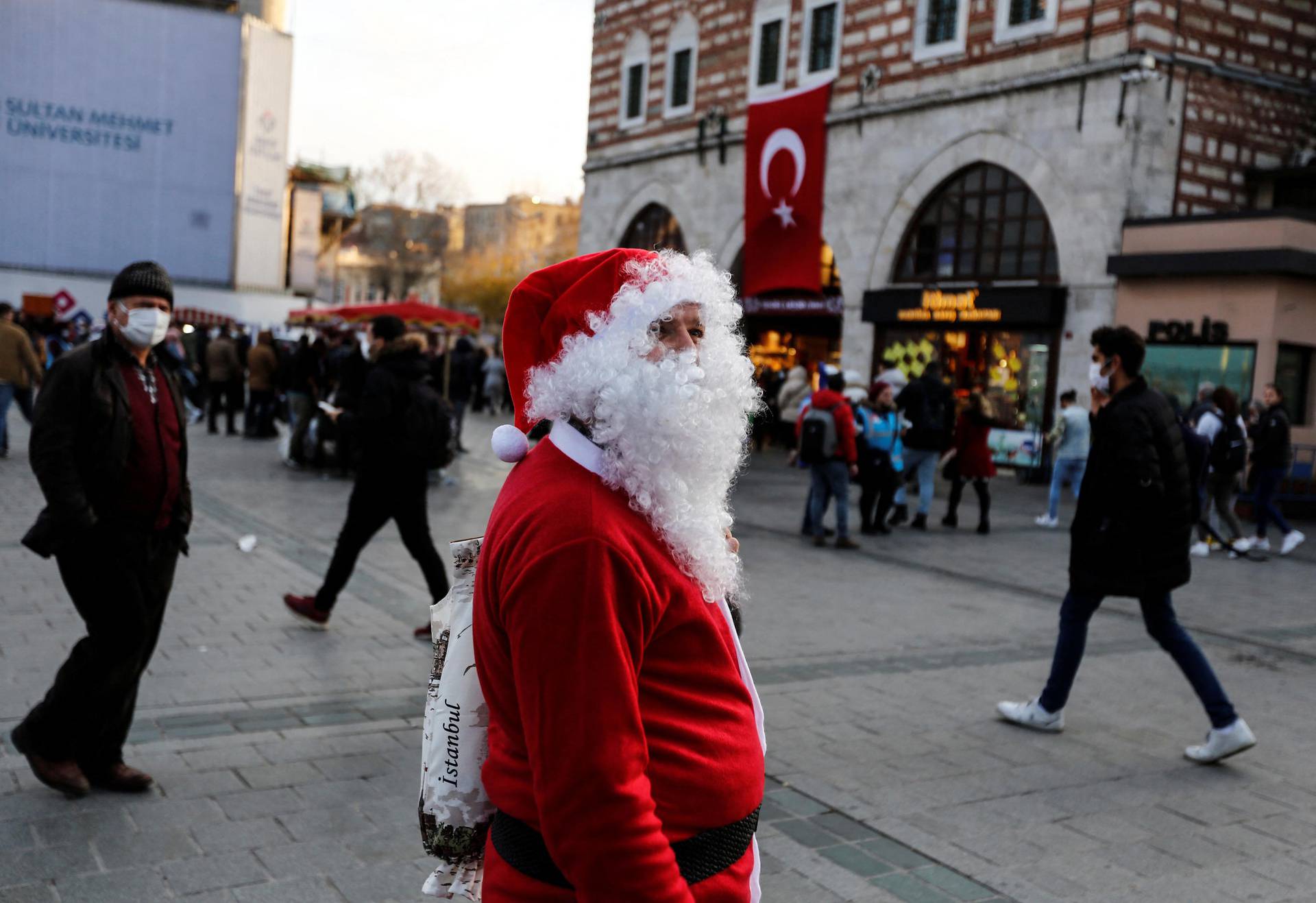 A man dressed as Santa Claus walks along Eminonu district ahead of New Year in Istanbul