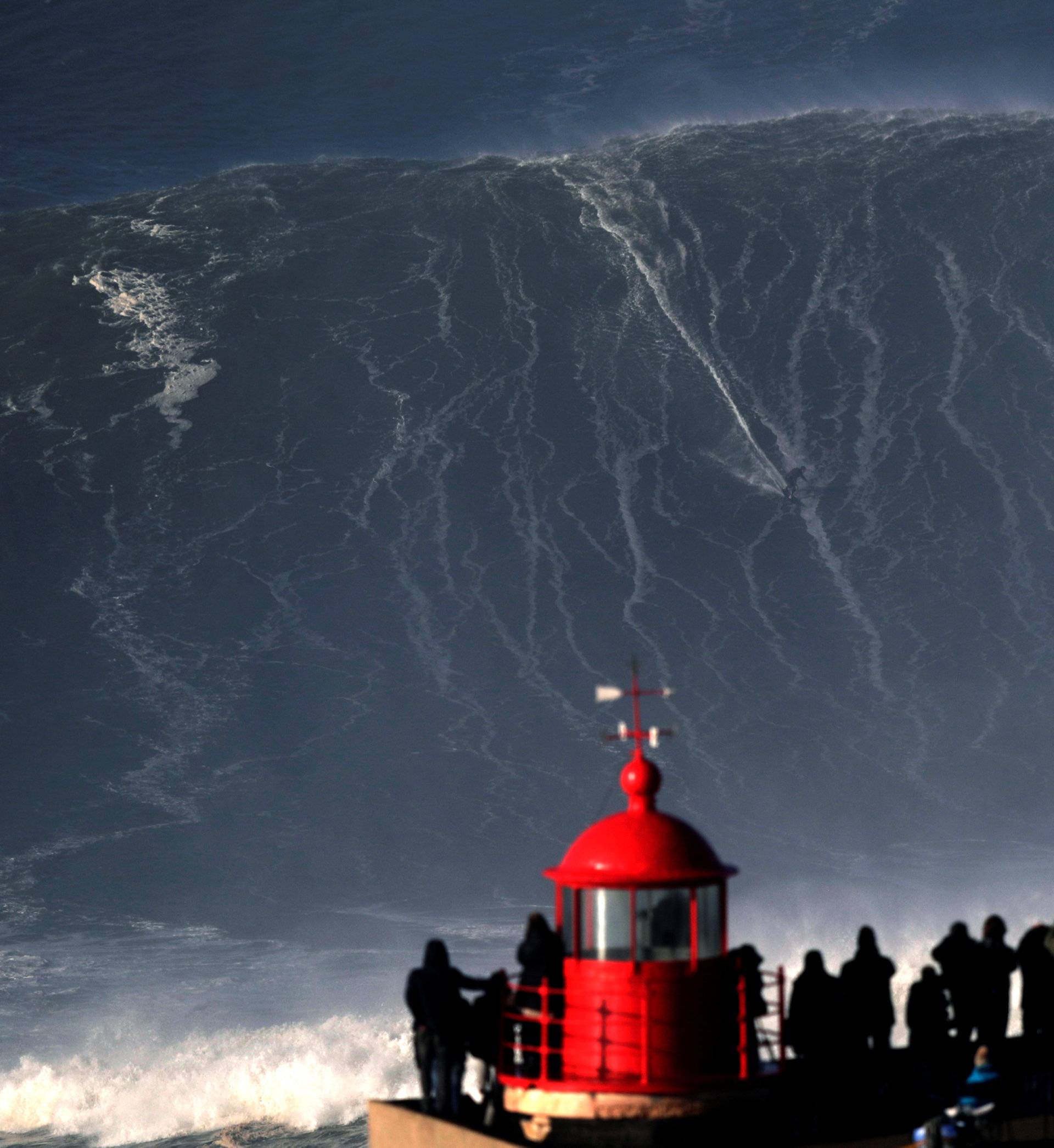 Big wave surfer Sebastian Steudtner of Germany drops in on a large wave at Praia do Norte in Nazare