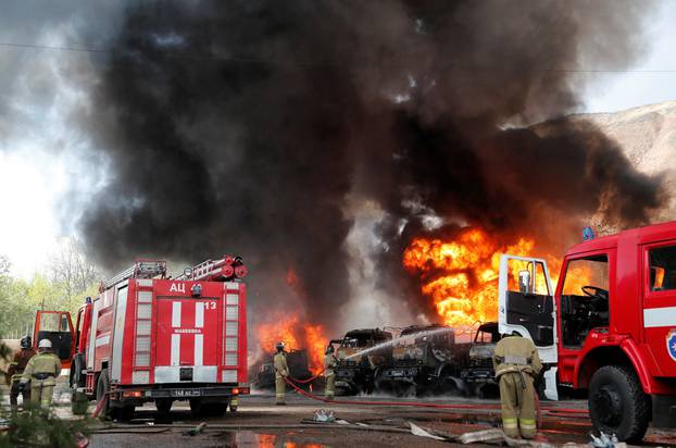 Specialists work to extinguish a fire at an oil storage in Donetsk