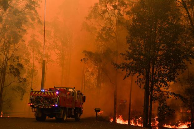 Fire trucks are seen during a bushfire in Werombi, 50 km southwest of Sydney
