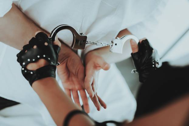 Woman Handcuffed Sexy Man in White Shirt on Bed.