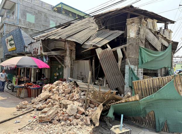 Rubble lies in front of a shop damaged by an earthquake in Taungoo