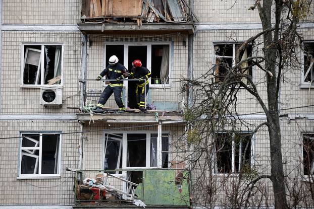 Emergency responders work at the site of a Russian drone strike on an apartment building, in Kyiv