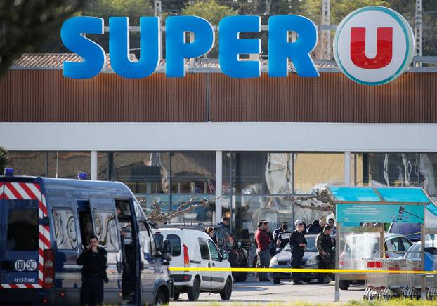 A general view shows gendarmes and police officers at a supermarket after a hostage situation in Trebes