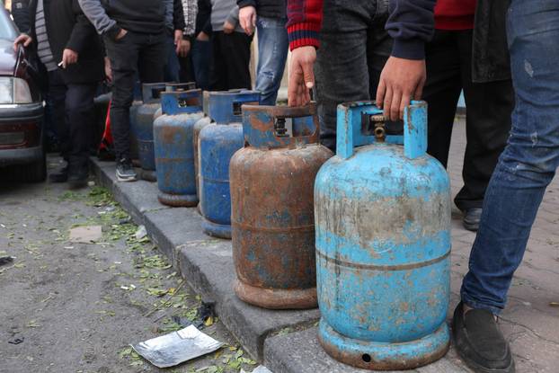 People queue to fill their gas cylinders in Damascus