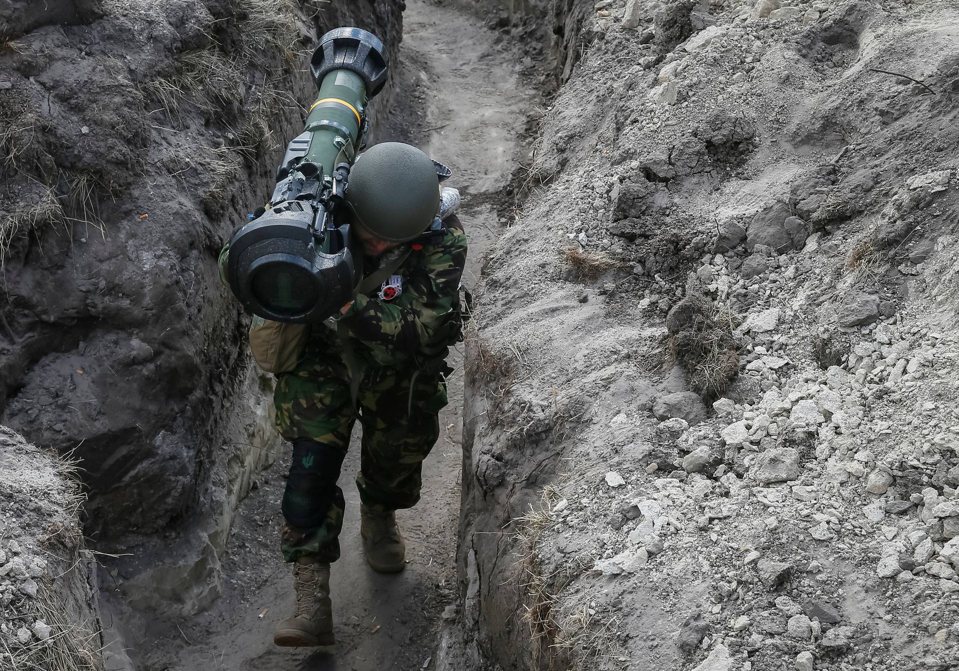 A Ukrainian service member is seen at a position on the front line in the north Kyiv region