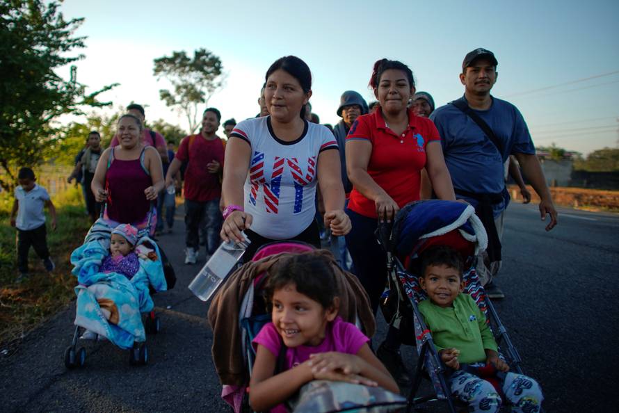 Migrant Celena Mejia, from Honduras, pushes a cart with her 6 year-old daughter during their journey towards the United States, in the outskirts of Ciudad Hidalgo, Mexico