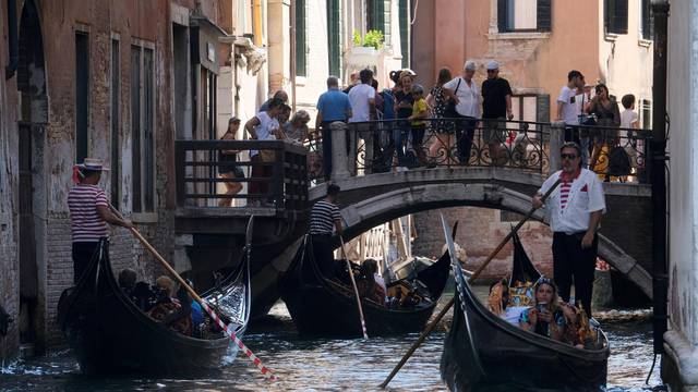 FILE PHOTO: Tourists visit Venice as the municipality prepares to charge them up to 10 Euro for entry into the lagoon city, in Venice