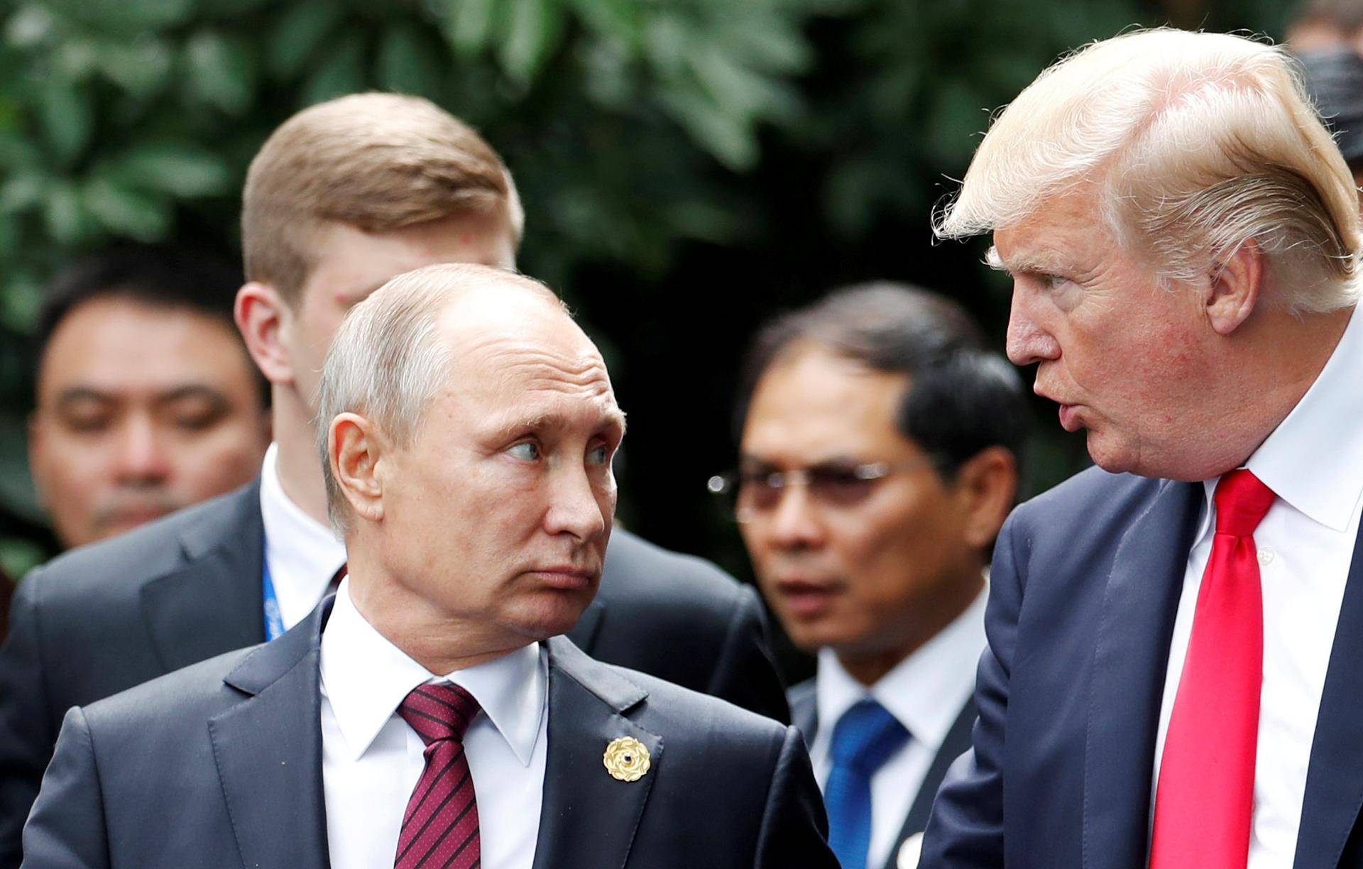 FILE PHOTO: U.S. President Donald Trump and Russia's President Vladimir Putin talk during the family photo session at the APEC Summit in Danang, Vietnam