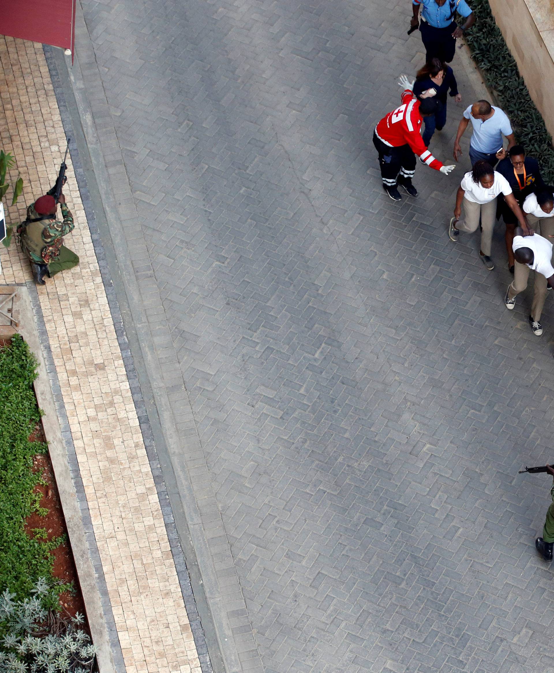 People are evacuated at the scene where explosions and gunshots were heard at the Dusit hotel compound, in Nairobi