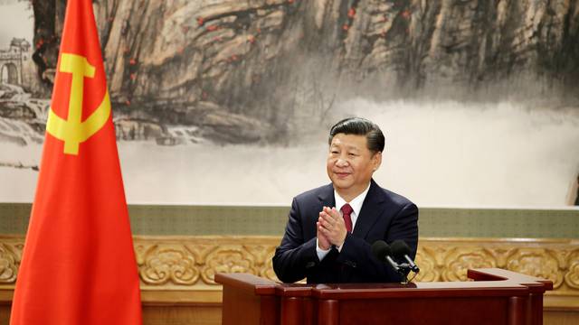 FILE PHOTO: Chinese President Xi Jinping claps after his speech as China's new Politburo Standing Committee members meet with the press at the Great Hall of the People in Beijing