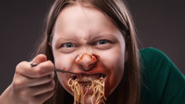 Teen girl furiously eating 