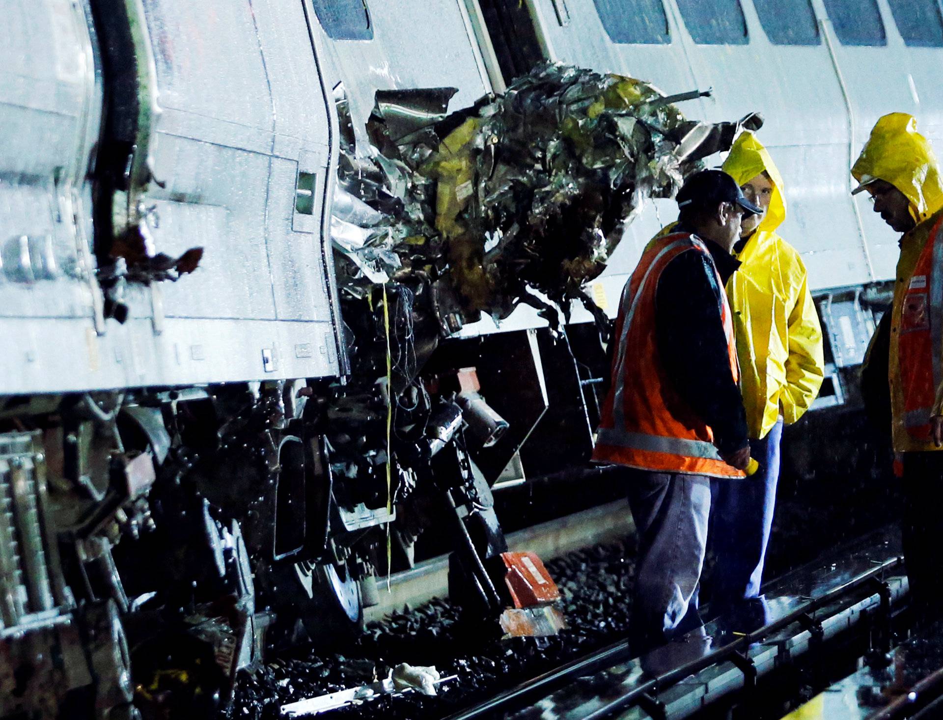 Emergency responders work near a train that sits derailed near the community of New Hyde Park on Long Island in New York