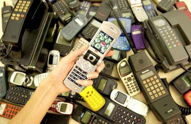 The history of mobile phones displayed with models from the 1980s to 3G videophones.