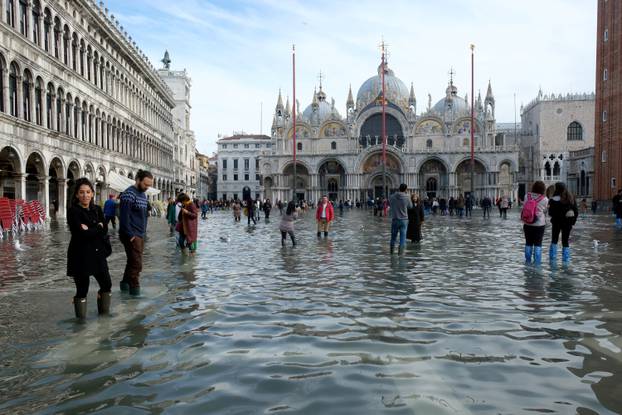 FILE PHOTO: Tourists walk in St. Mark’s Square after days of severe flooding in Venice