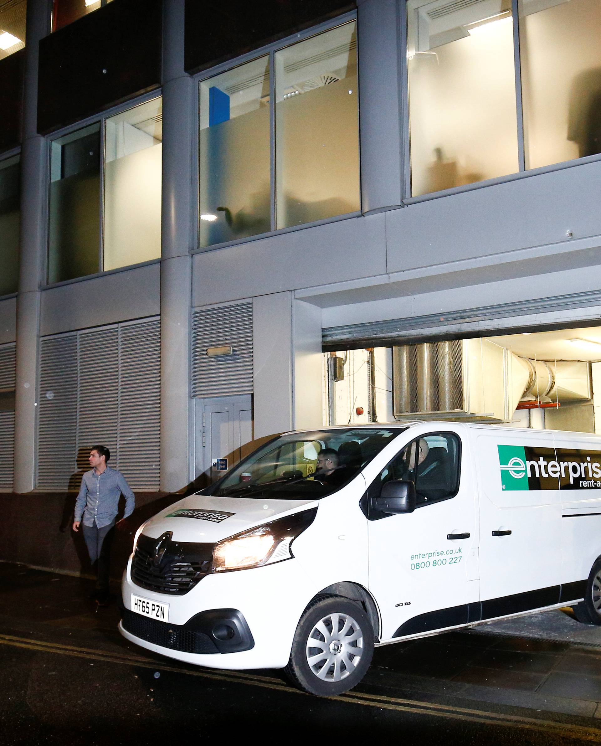 A van and a group of people leave the building which houses the offices of Cambridge Analytica as investigators from Britain's Information Commissioners Office entered, following the granting of a search warrant by a High Court judge, in London