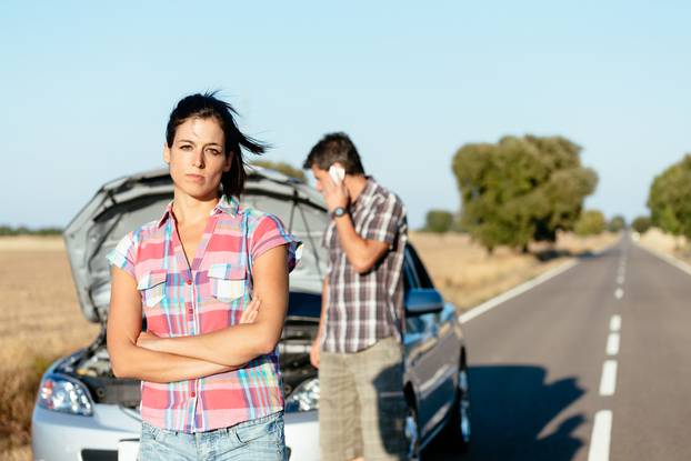 Upset,Woman,Waiting,For,Car,Help,While,Man,Arguing,On