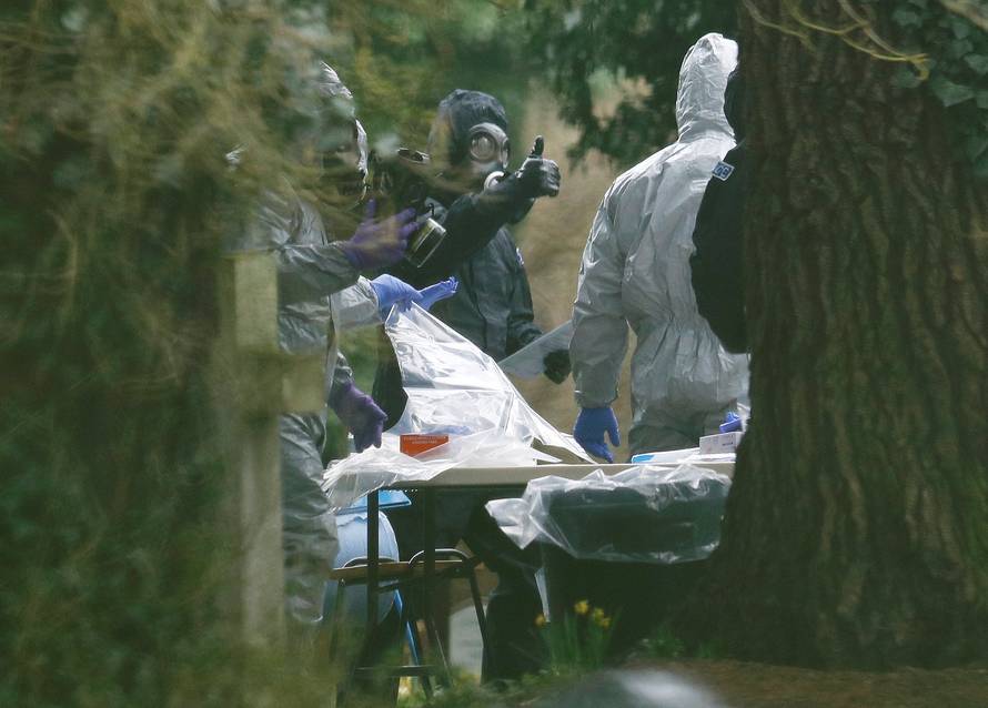 Members of the emergency services wear protective suits at the site of the grave of Luidmila Skripal, wife of former Russian inteligence officer Sergei Skripal, at London Road Cemetery in Salisbury