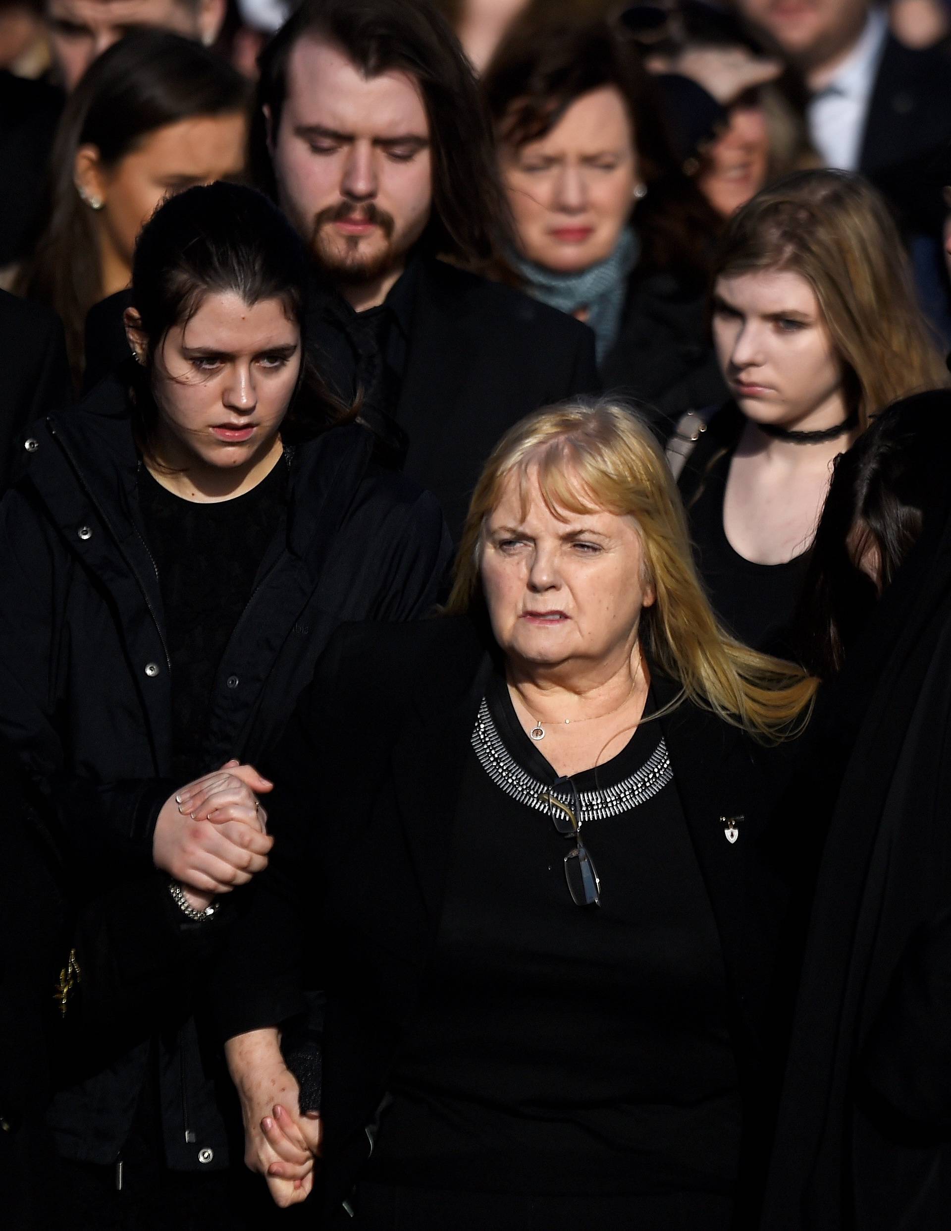 Eillen O'Riordan leaves her daughter Dolores O'Riordan's funeral with Dolores' ex-husband Don Burton and one of their daughters at St Ailbe's Church in Ballybricken