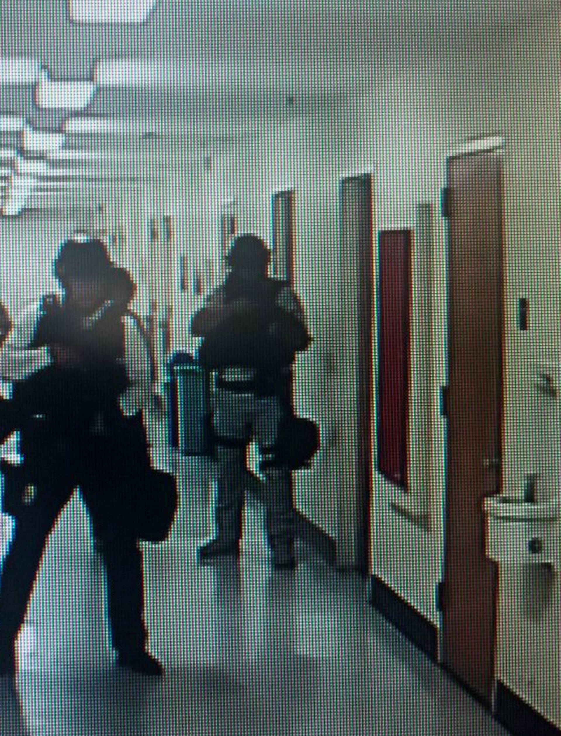 Police officers search corridors and rooms after the report of an active shooter on a UCLA campus in Los Angeles