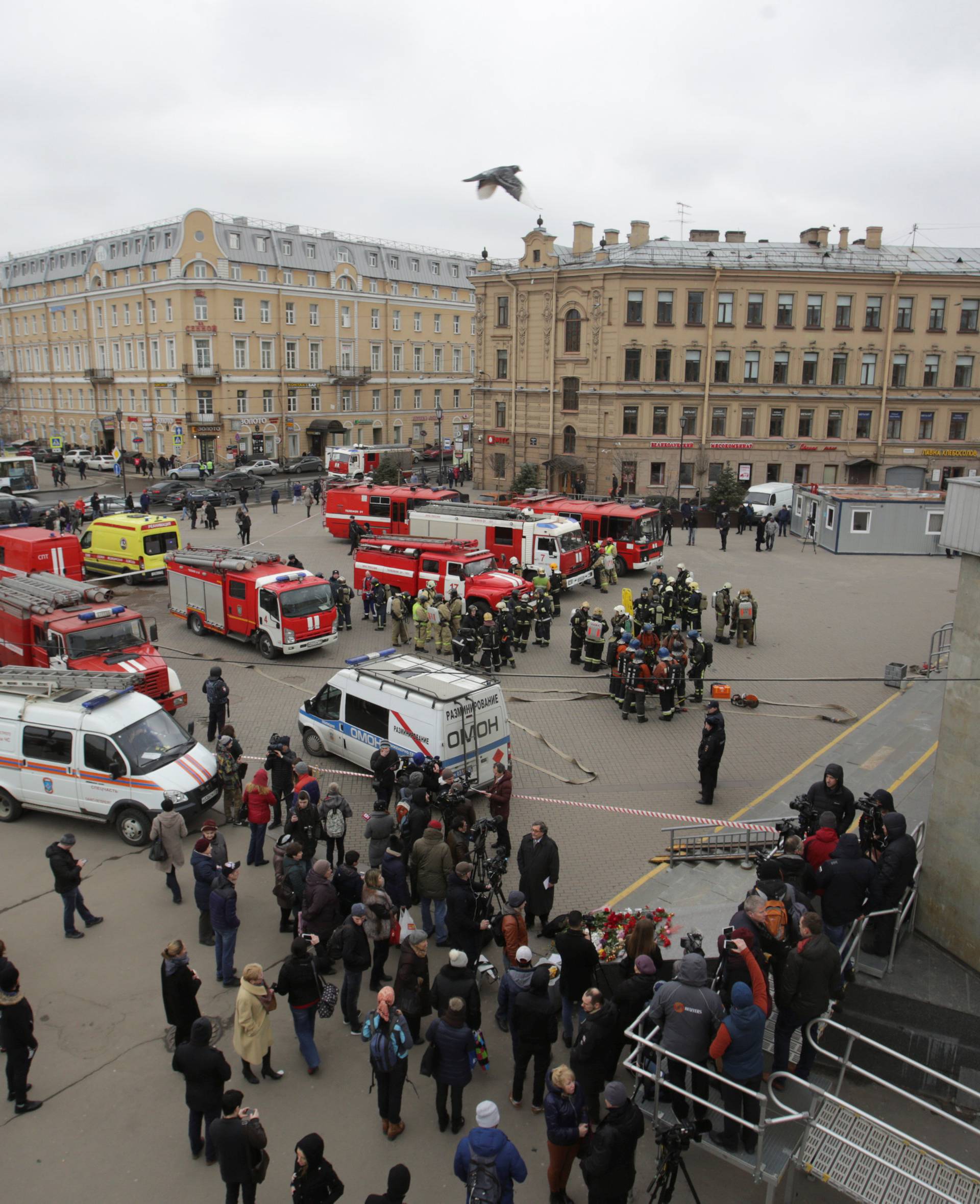 Security and the emergency services are seen near Sennaya Ploshchad metro station which was closed over an anonymous call of a bomb threat in the underground, in St. Petersburg