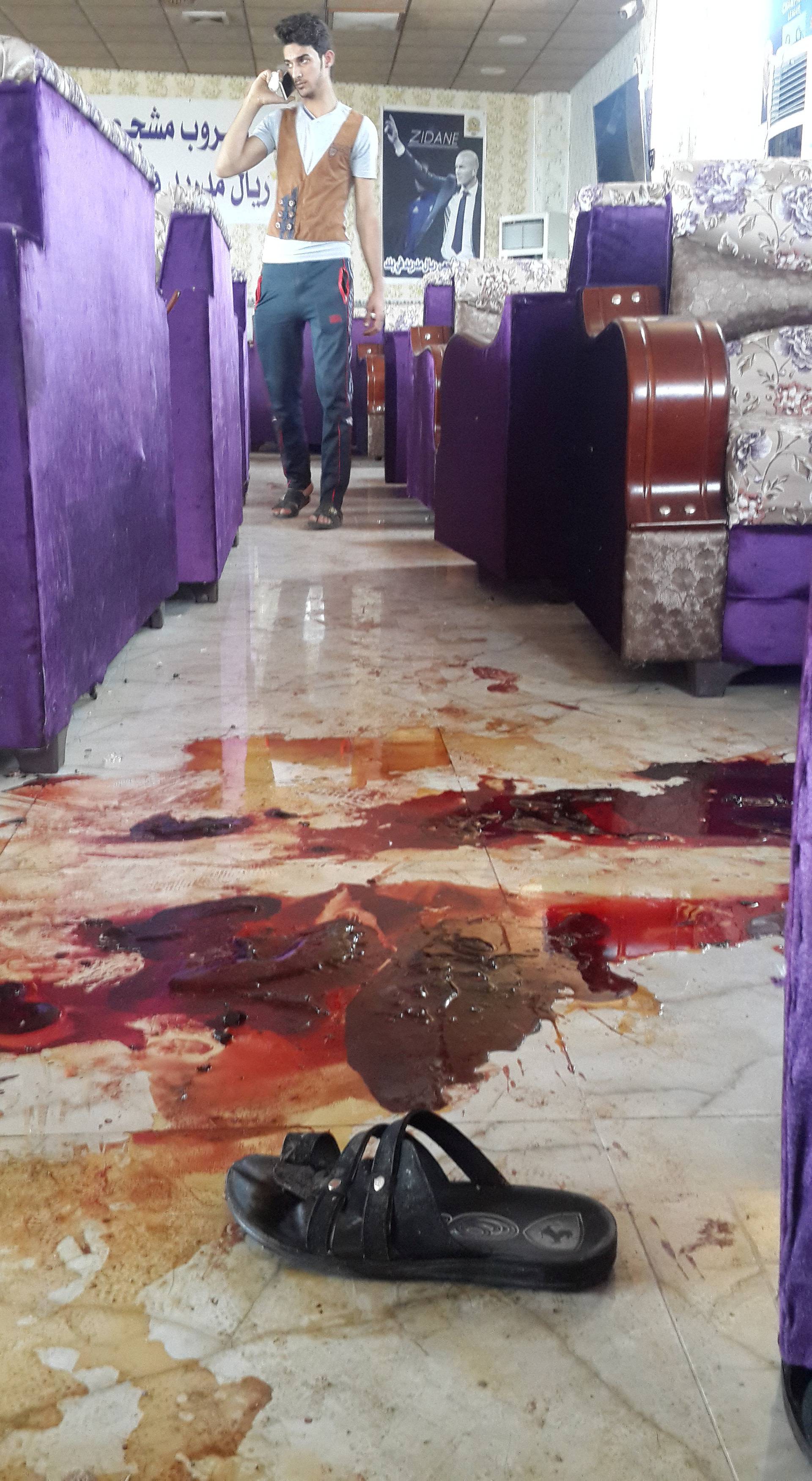 Blood stains are seen at a cafe in the predominately Shi'ite Muslim town of Balad