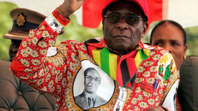 FILE PHOTO: Zimbabwe's President Robert Mugabe gestures at an election rally in the small town of Shamva