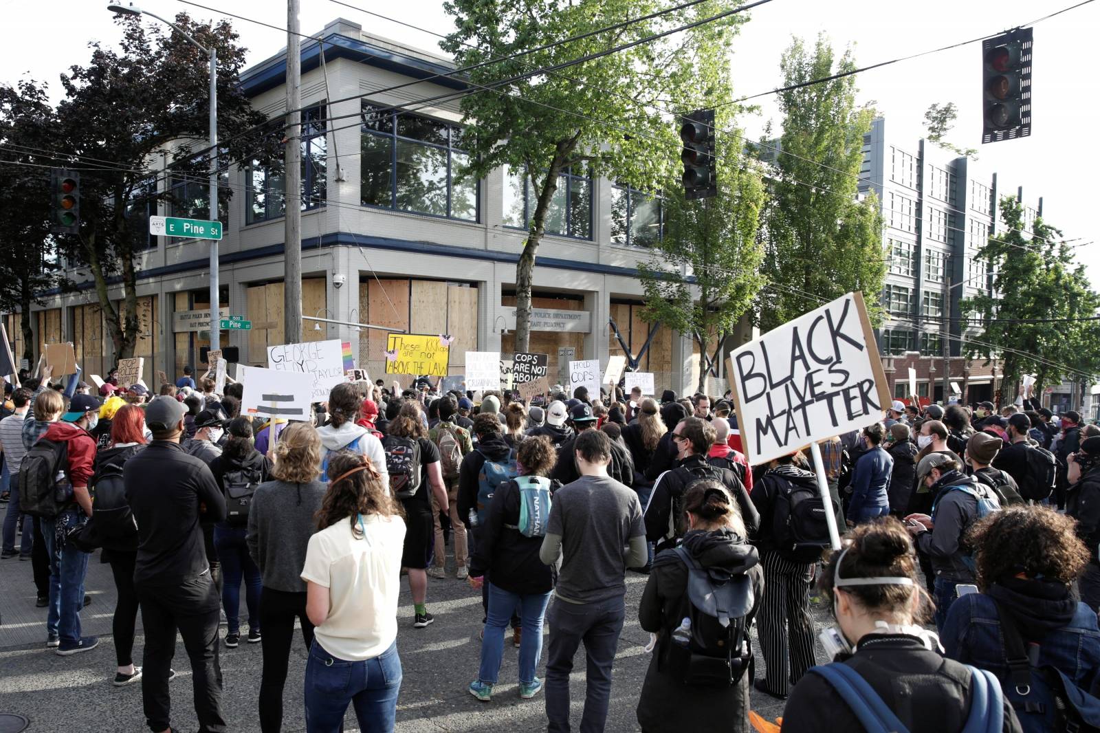 Protesters demonstrate outside the Seattle Police Department's East Precinct after the building was boarded up and vacated in Seattle