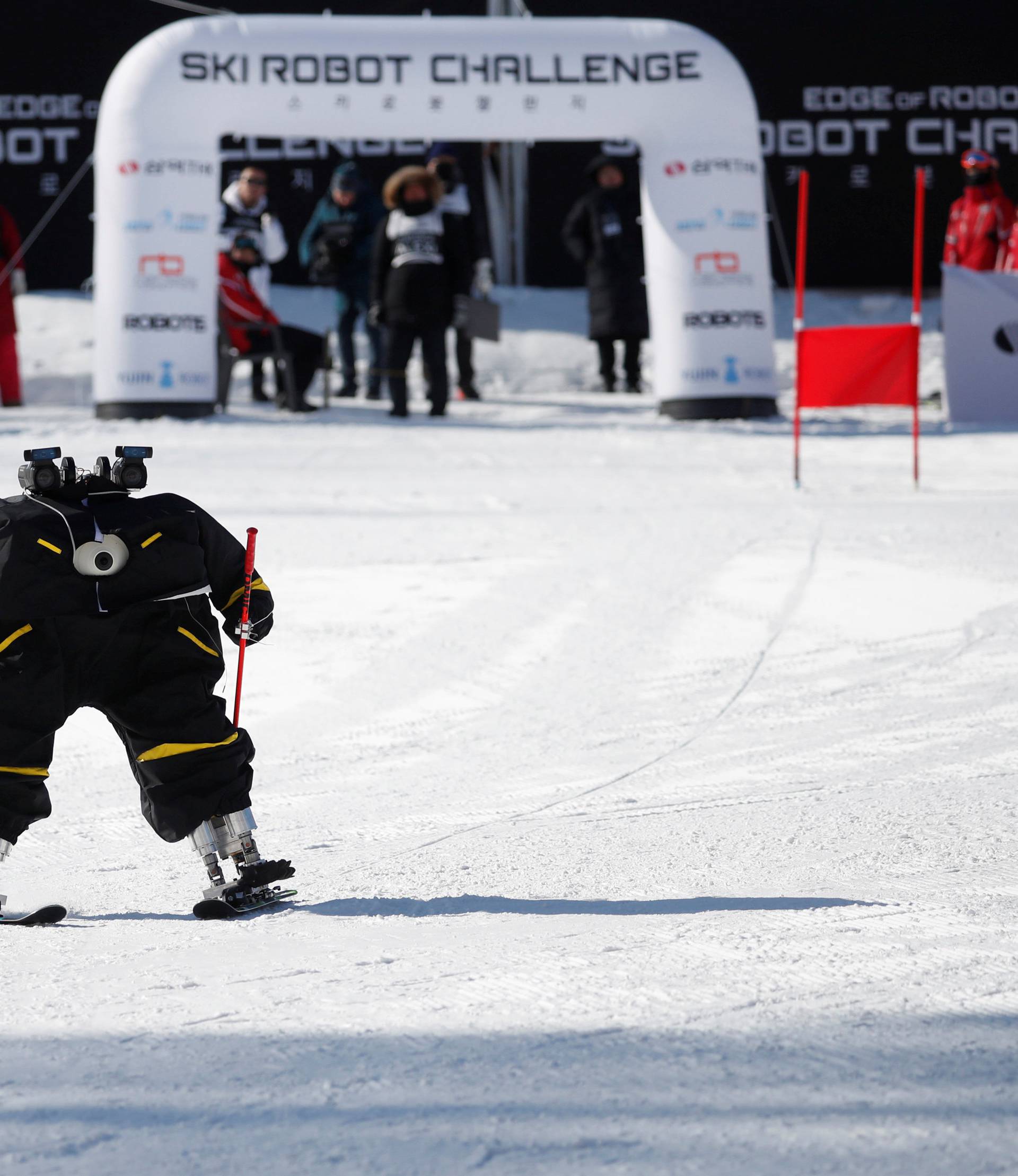 Robot Alexi skies during the Ski Robot Challenge at a ski resort in Hoenseong