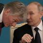 FILE PHOTO: Russian President Vladimir Putin talks to Kremlin spokesman Dmitry Peskov