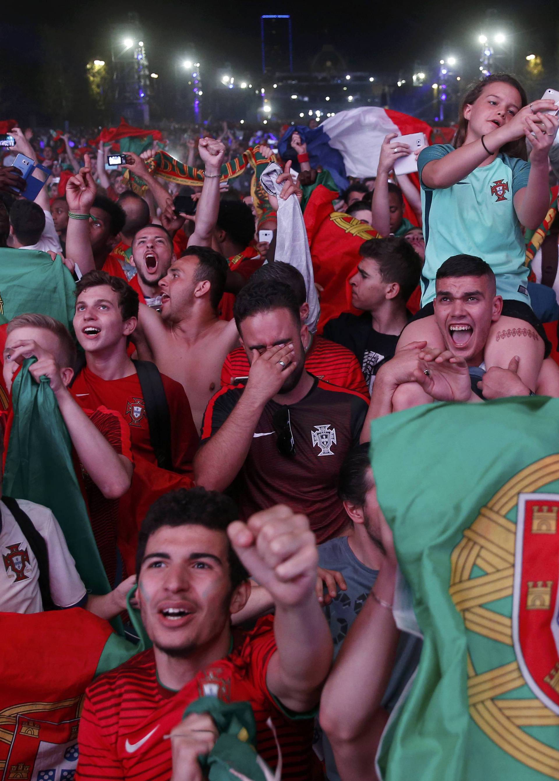 Portugal fans react at Paris fan zone during a EURO 2016 final soccer match       