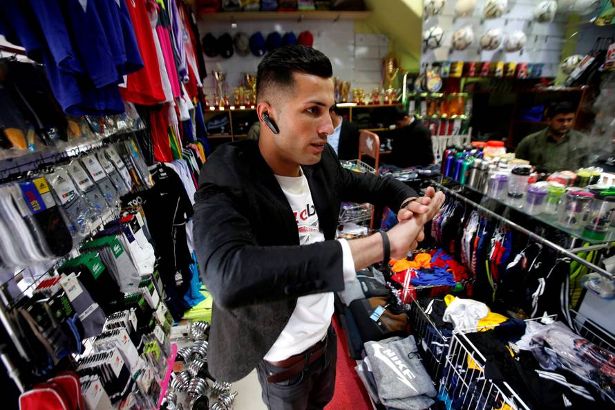 Biwar Abdullah, 25, an Iraqi Kurdish local footballer, who looks like the football player Cristiano Ronaldo, is seen at a sportswear shop in the district of Soran, northeast of Erbil