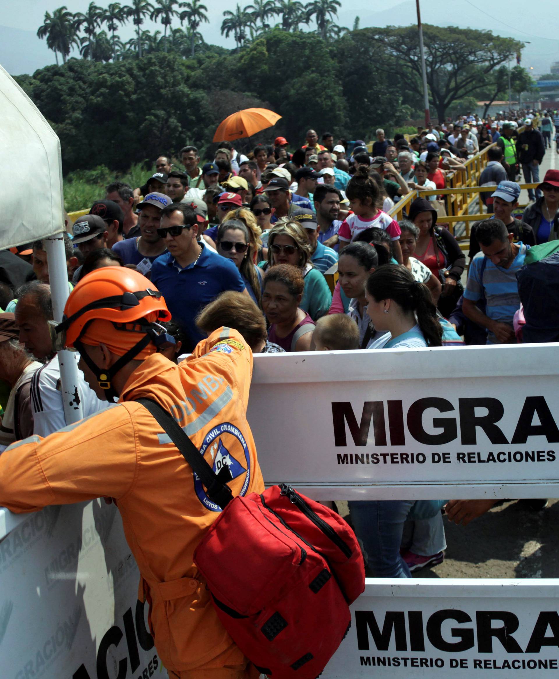 People cross the Colombian-Venezuelan border over the Simon Bolivar international bridge in Villa del Rosario