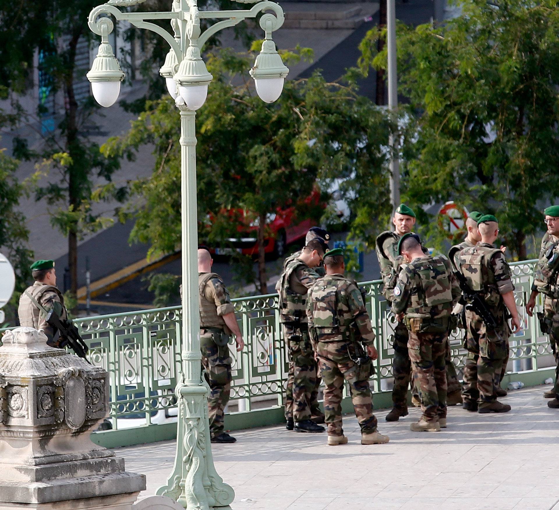 Soldiers gather outside the Saint-Charles train station after French soldiers shot and killed a man who stabbed two women to death at the main train station in Marseille