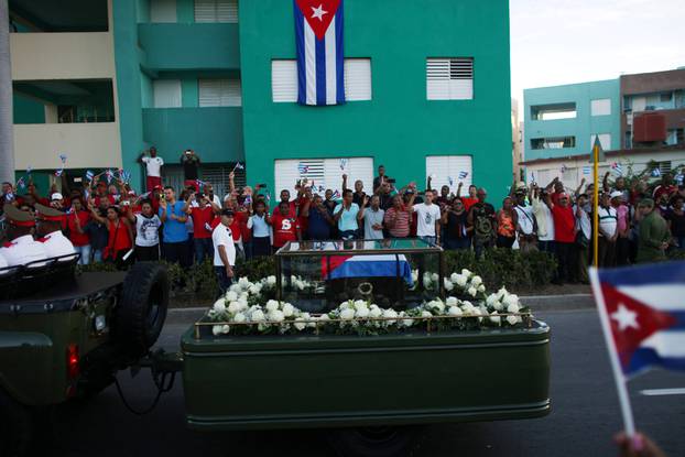 People watch the cortege carrying the ashes of Cuba