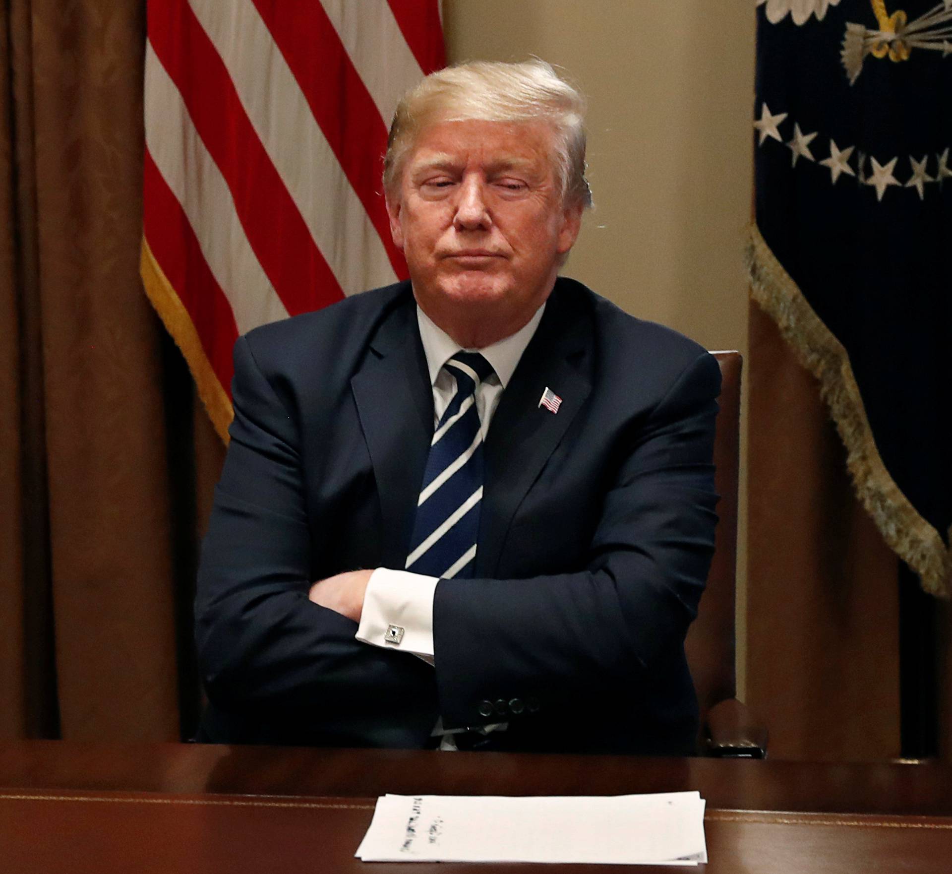 U.S. President Trump waits for reporters to leave the room after speaking about his summit with Russia's President Putin in meeting at the White House in Washington