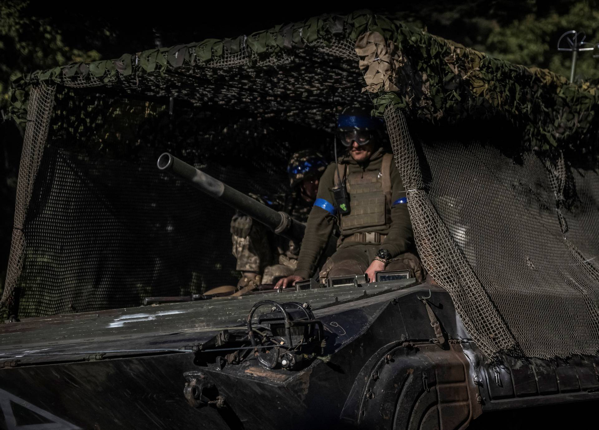 Ukrainian servicemen ride a BMP-1 infantry fighting vehicle near the Russian border in Sumy region