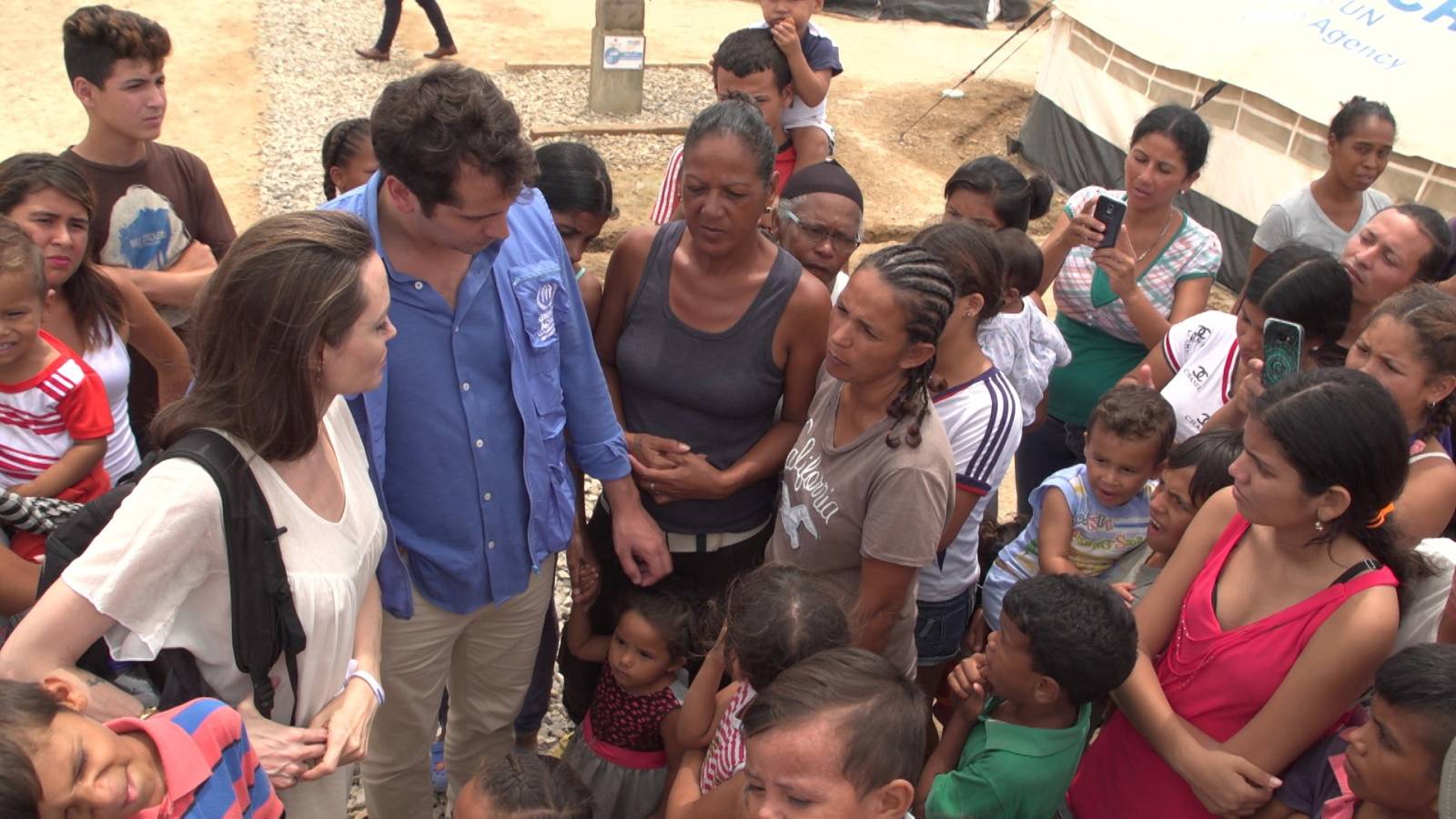UNHCR special envoy Angelina Jolie talks to people inside a camp run by the UNHCR in Maicao