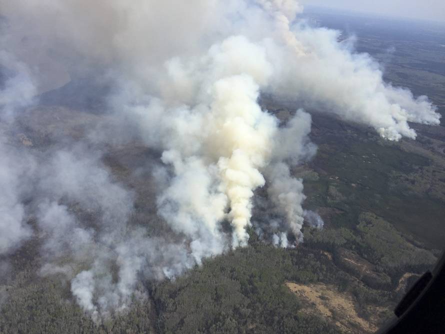 An aerial view from the helicopter of Alberta Premier Rachel Notley shows smoke rising from raging wildfires which caused the mandatory evacuation of Fort McMurray