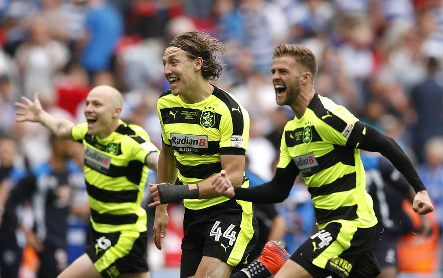 Huddersfield Town's Aaron Mooy, Michael Hefele and Martin Cranie celebrate after winning the Sky Bet Championship Play-Off Final and getting promoted to the Premier League
