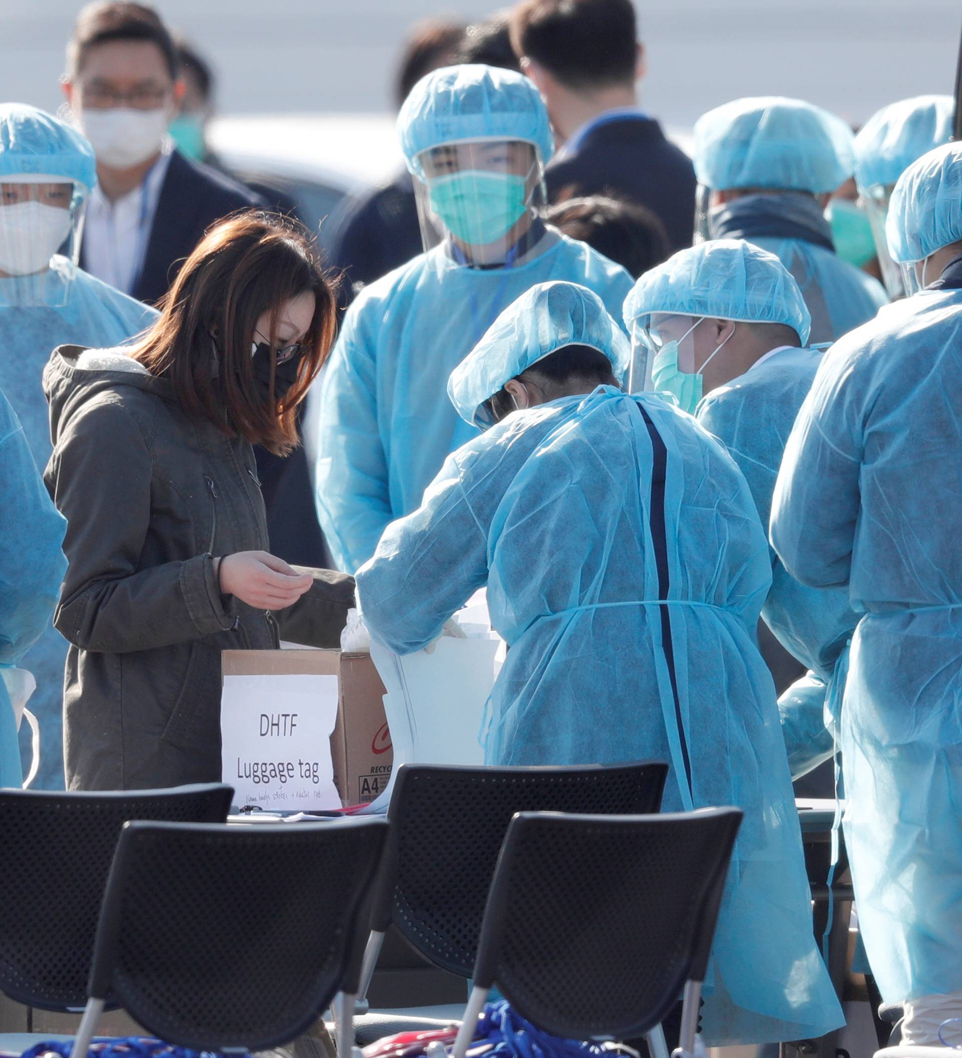 Passengers wearing masks leave cruise ship Diamond Princess at Daikoku Pier Cruise Terminal in Yokohama