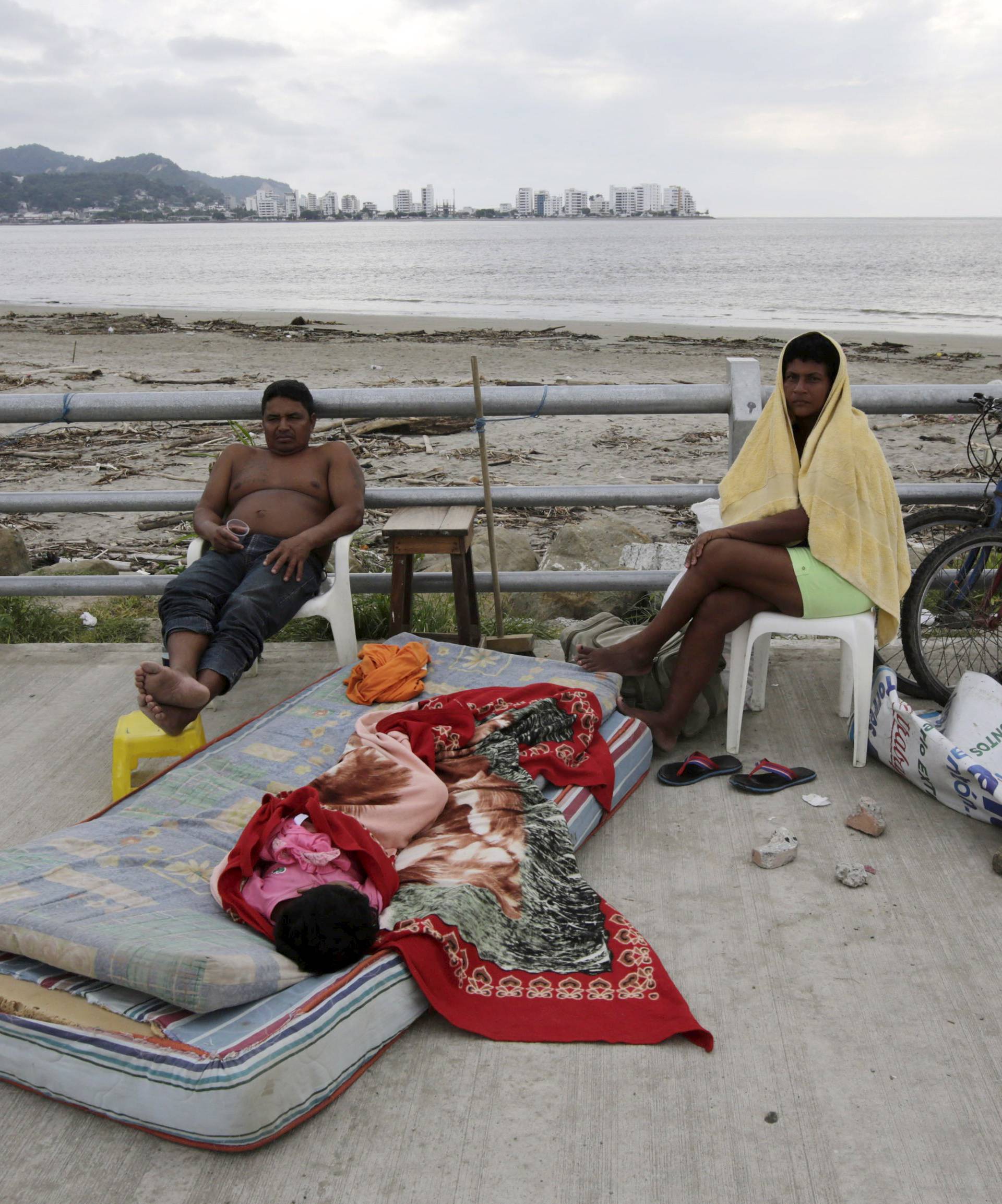 A family rests along Bahia de Caraquez following the earthquake in Ecuador