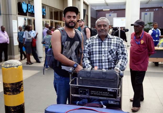 Passanger Ahmed Khalid, who missed his Ethiopian Airlines Flight ET 302 while connecting from Dubai, is received by his father Khalid Bzambur at the Jomo Kenyatta International Airport (JKIA) in Nairobi,